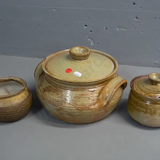 3 pieces of New Zealand studio pottery - lidded casserole marked KM on base, lidded sugar or honey and small pot, both