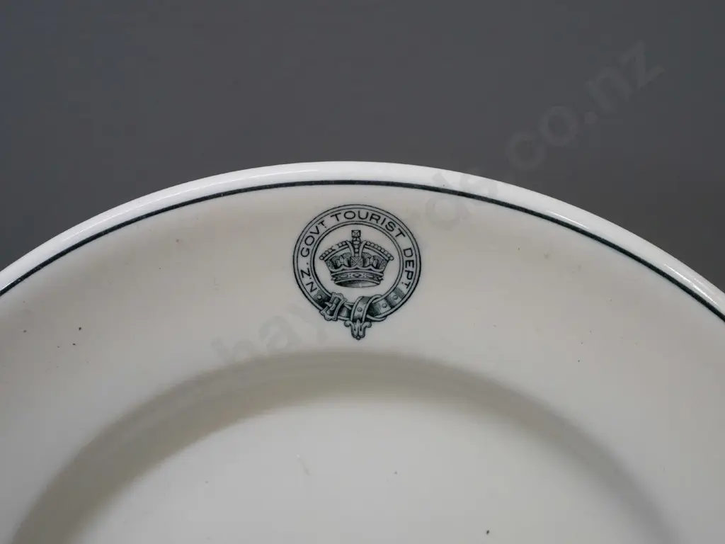 2 Royal Doulton plates with New Zealand Government Tourist Department logo and a deco Picquot ware teapot with wood Image 1++