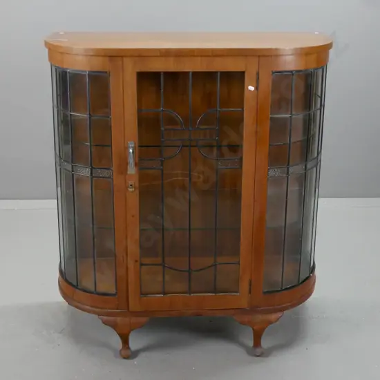 vintage art deco walnut veneer bow-front china cabinet on short cab legs, with geometric leadlight doors, 2 fixed glass