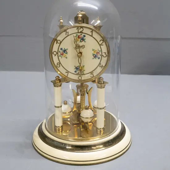Schatz German glass-domed anniversary clock -brass and enamel with floral spray motifs H-300 D-190