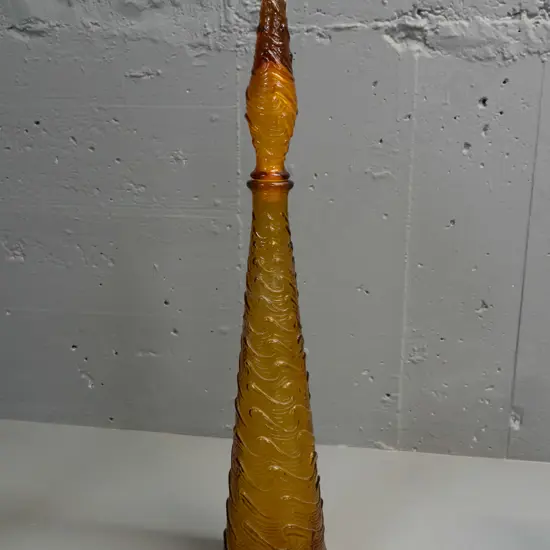 moulded amber glass stoppered genie bottle with wave design, 'Made in Italy' stamped in base - powdery white residue