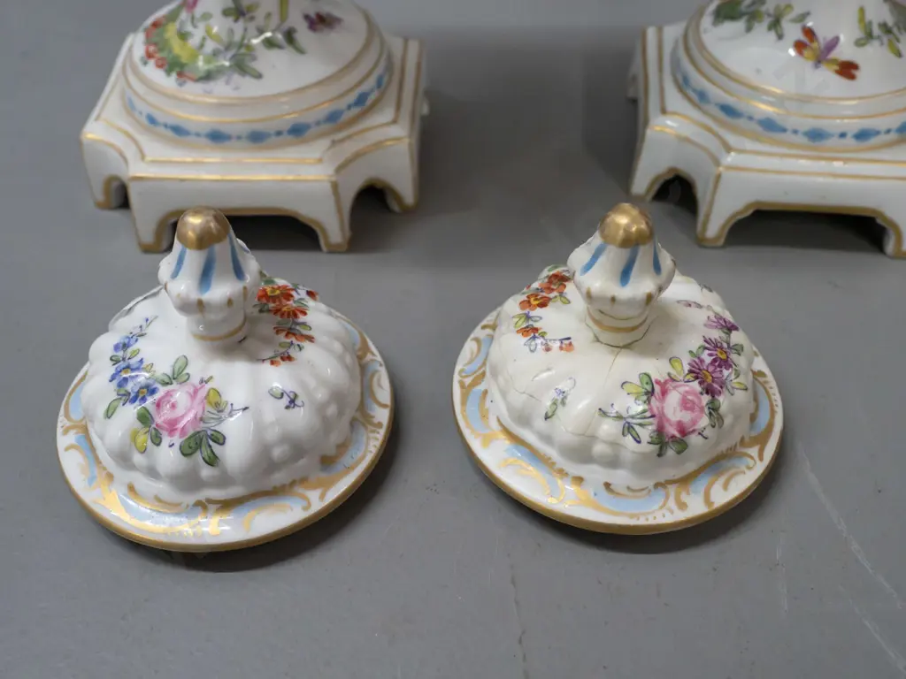 pair of Chelsea pottery hand painted and gilded bird motif lidded urns on platform base, swirled fluted body shape Image 1++