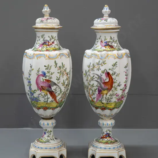 pair of Chelsea pottery hand painted and gilded bird motif lidded urns on platform base, swirled fluted body shape