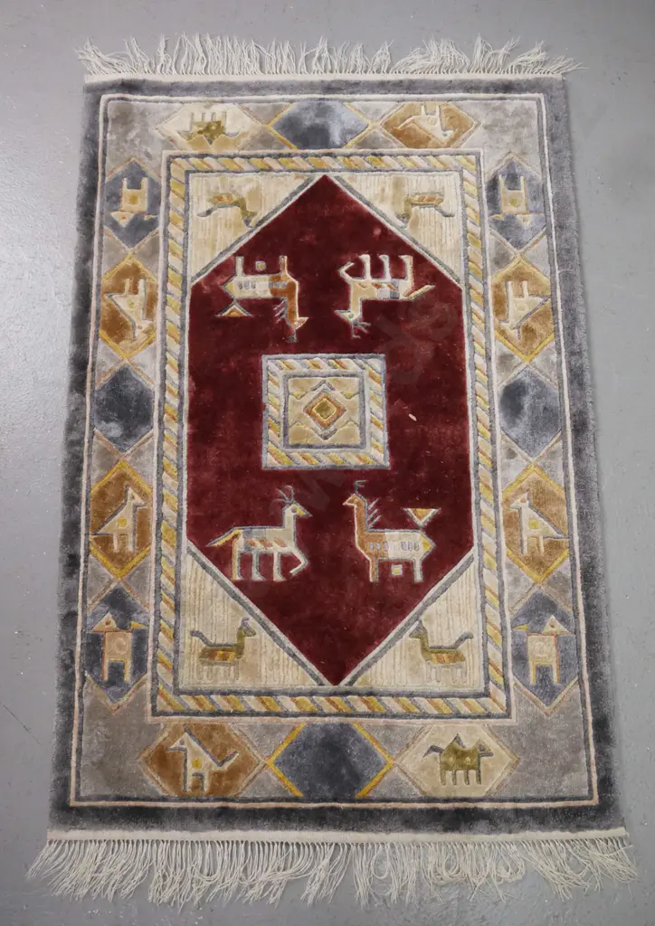 small wool floor rug with geometric animal motifs in red, blue, gold and beige L-940 W-610 Image 1++