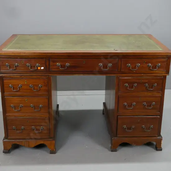 double pedestal oak and mahogany veneer Chippendale style desk with green leather, gold tooled top.