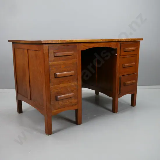 vintage oak double pedestal desk with panelled sides and kneehole, 3 kauri lined drawers on right, door with dummy