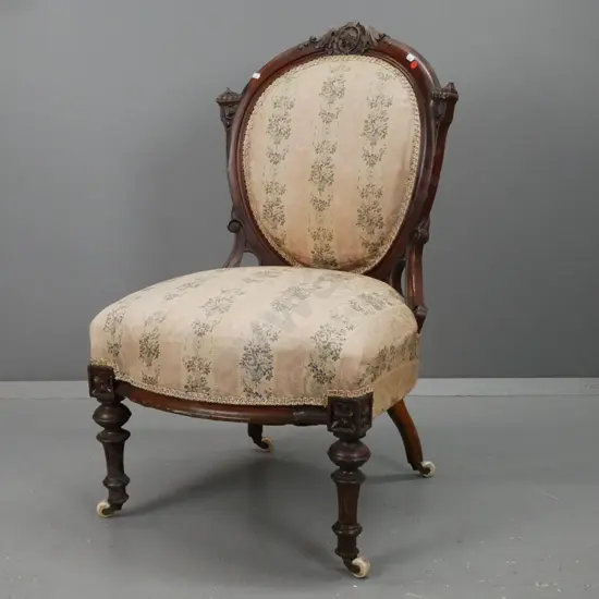 Victorian walnut cameo-back chair with carved back, turned and fluted front legs, white porcelain casters with crowns.