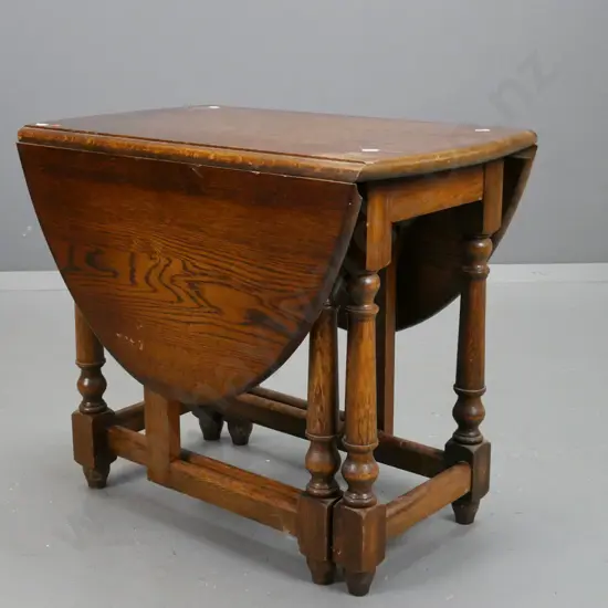small oak vintage gate leg table with turned legs and supports on stretcher base. Scratching and wear