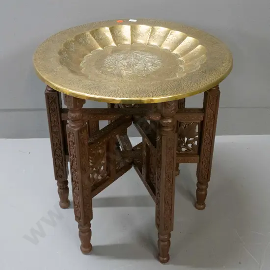 Indian brass tray table with fluted inner rim, floral etched motifs, sitting on folding carved hardwood base H-410 D-380