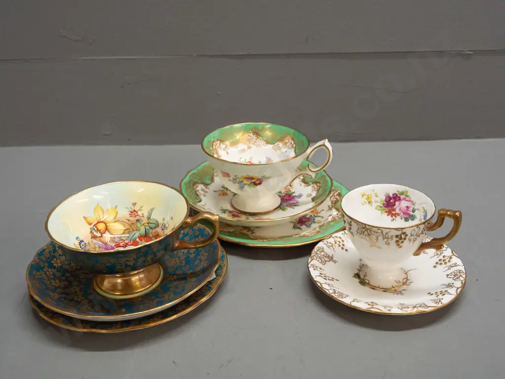 2 vintage Hammersley gilded rim trios, one with floral cup signed F. Howard - and a Crown Derby "Vine" coffee cup Image 1++
