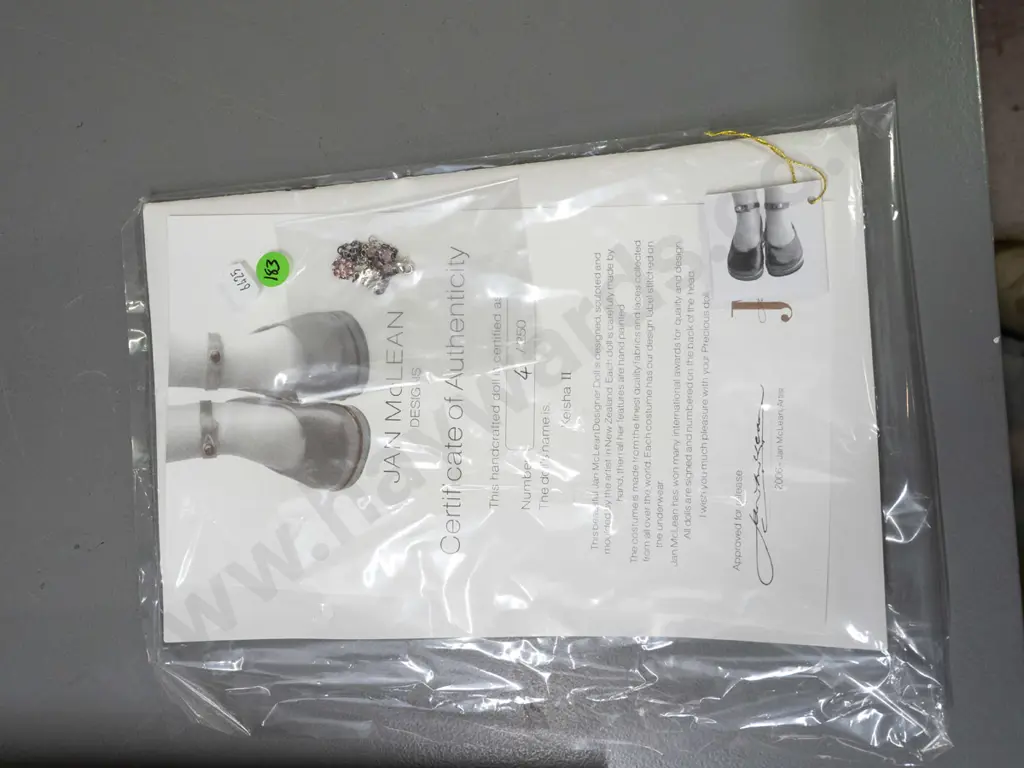 Jan Mclean 2006 "Keisha II" seated doll and companion doll, in original packaging with stand, documents and certificate Image 1++