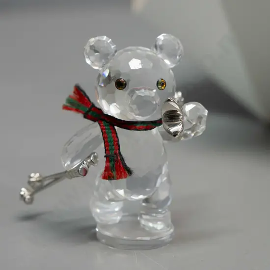 Swarovski crystal cased Teddy bear with skis, ski poles, and striped scarf, in original box. H-45