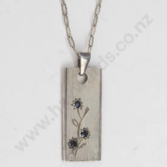 silver ingot with 3 red stones stamped 925