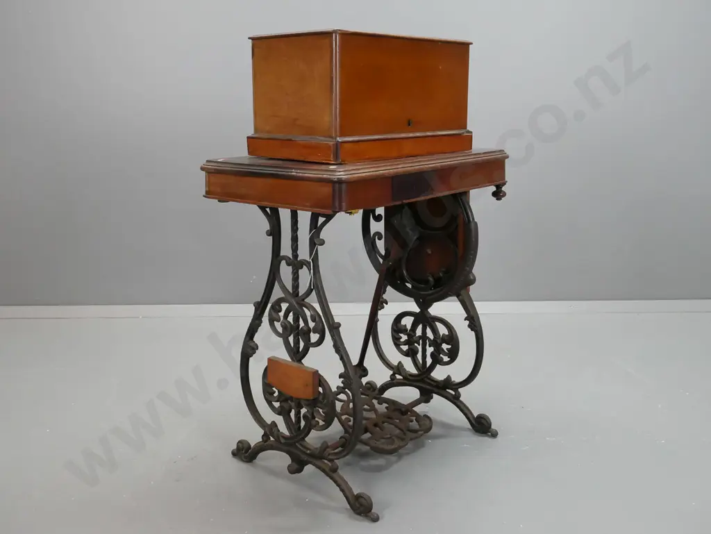 antique Wilcox and Gibbs NY treadle sewing machine on compact walnut and cast iron base with accessories in drawer, lift Image 1++