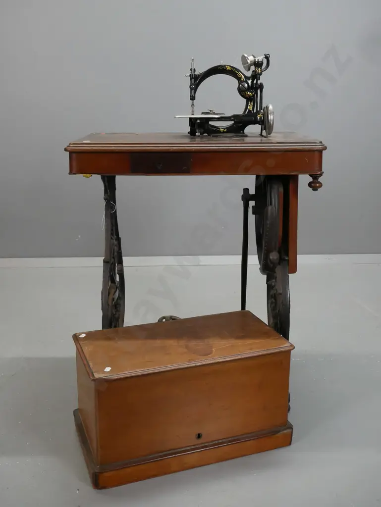 antique Wilcox and Gibbs NY treadle sewing machine on compact walnut and cast iron base with accessories in drawer, lift Image 1++