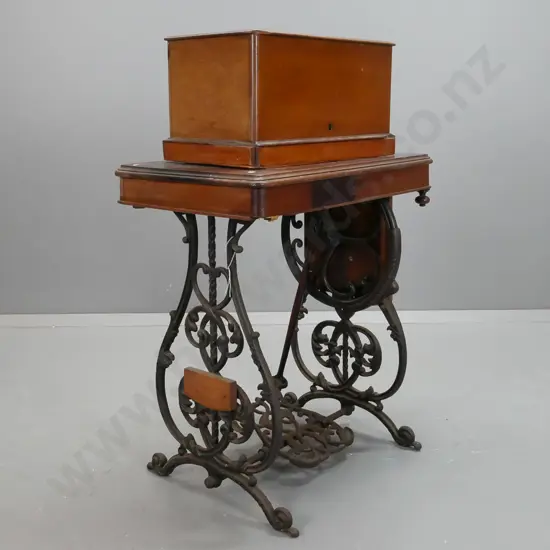 antique Wilcox and Gibbs NY treadle sewing machine on compact walnut and cast iron base with accessories in drawer, lift