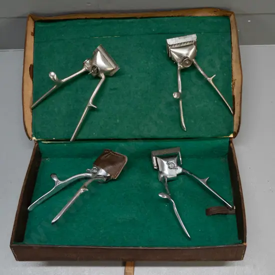 lined leather case with 4 vintage hair clippers, varying makes - 2x Burman England, John Oster Racine USA, one unmarked