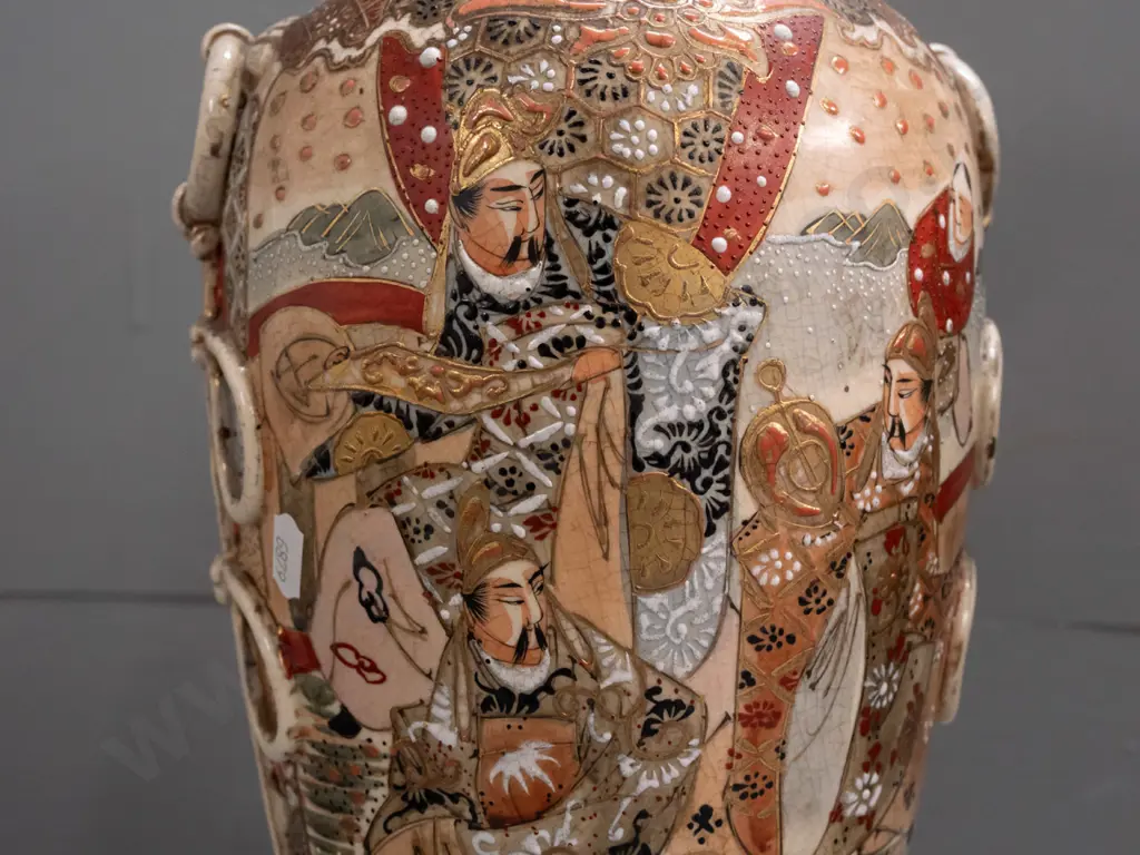 pair of Satsuma earthenware vases with frilled top, applied handles and panels of battle scene decoration, minor crack Image 1++
