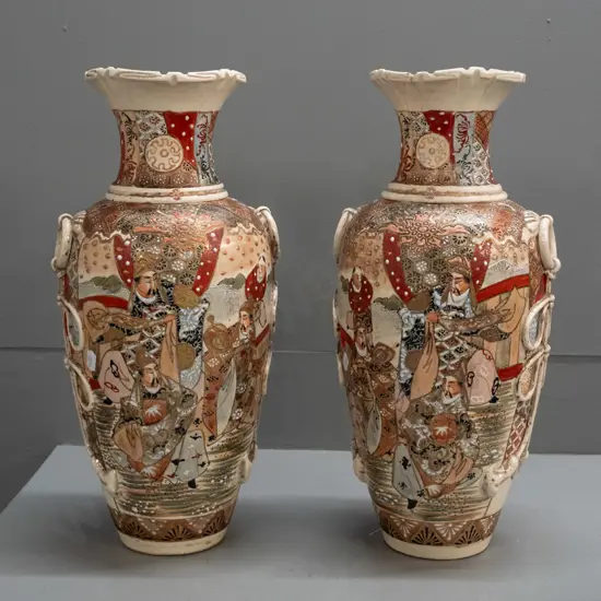 pair of Satsuma earthenware vases with frilled top, applied handles and panels of battle scene decoration, minor crack
