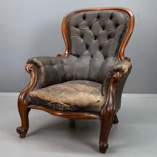 Victorian mahogany cab-leg armchair with carved sweeping arm support and back, buckram deep-button and pleated back,