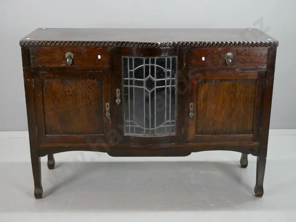 vintage art deco oak sideboard with moulded coin decorated edge, central leadlight door with working locks and key, Image 1++