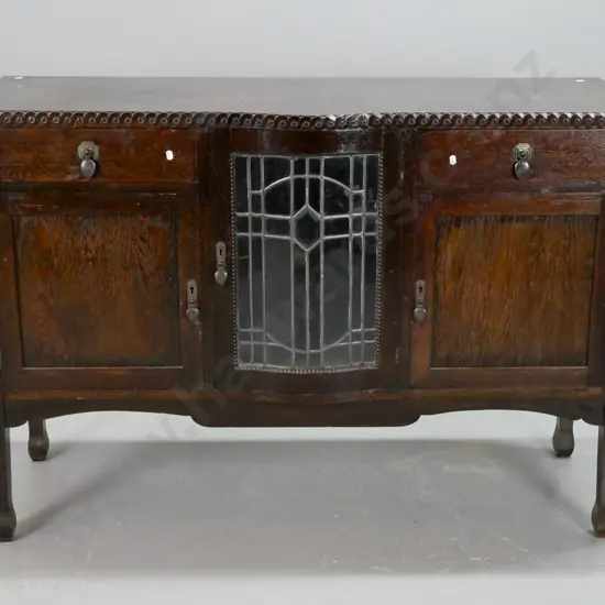 vintage art deco oak sideboard with moulded coin decorated edge, central leadlight door with working locks and key,