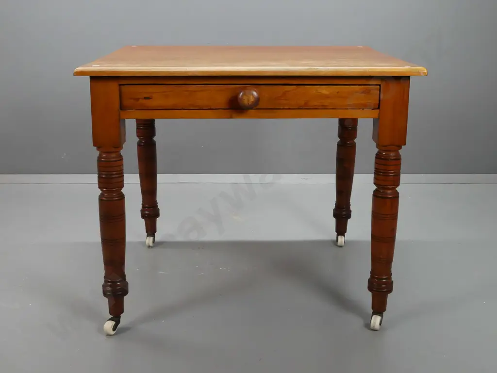 New Zealand colonial rimu table / desk with turned legs, porcelain casters, single partially fitted drawer with turned Image 1++