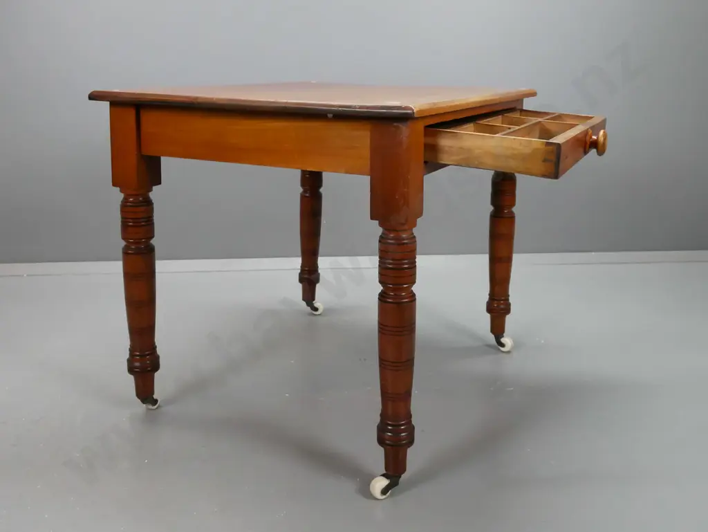New Zealand colonial rimu table / desk with turned legs, porcelain casters, single partially fitted drawer with turned Image 1++