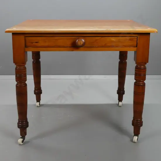 New Zealand colonial rimu table / desk with turned legs, porcelain casters, single partially fitted drawer with turned