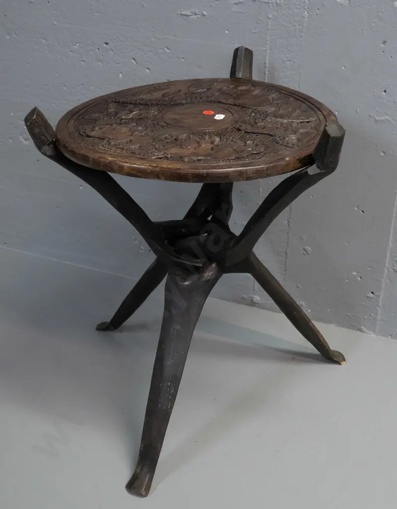 collapsible African carved hardwood table with tripod base, elephants and other animals in top, some cracks and drilled Image 1++