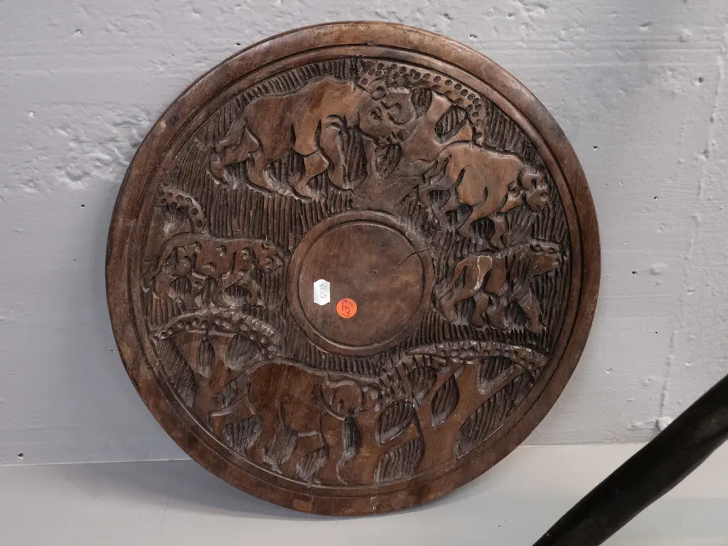 collapsible African carved hardwood table with tripod base, elephants and other animals in top, some cracks and drilled Image 1++