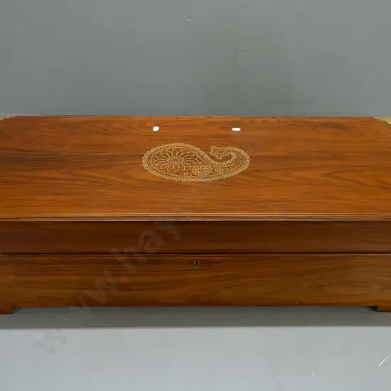 large brass bound rosewood chest with brass bound corners, brass wire inlay motif on top, on block feet, working lock w/