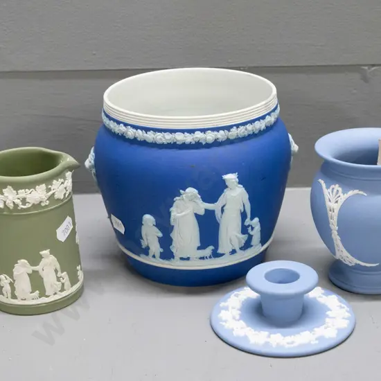 4 pieces of Wedgwood Jasperware - dark blue jardiniere H-130 D-130, light blue vase and candlestick, and a green jug.