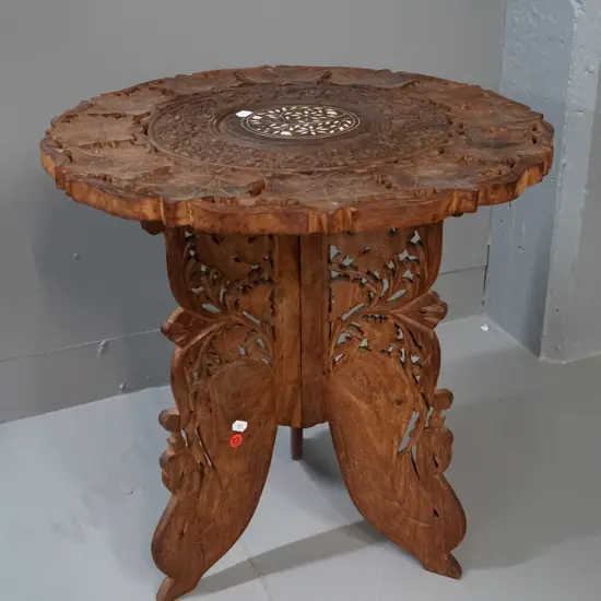 Indonesian carved hardwood collapsible table with hinged 3-piece base and lift-off top with bone inlay - some staining
