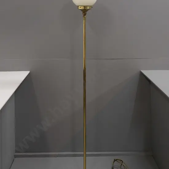 brass standard lamp on circular cast brass base with 6 scrolling feet, brass upright and journal, ivory globe shade -