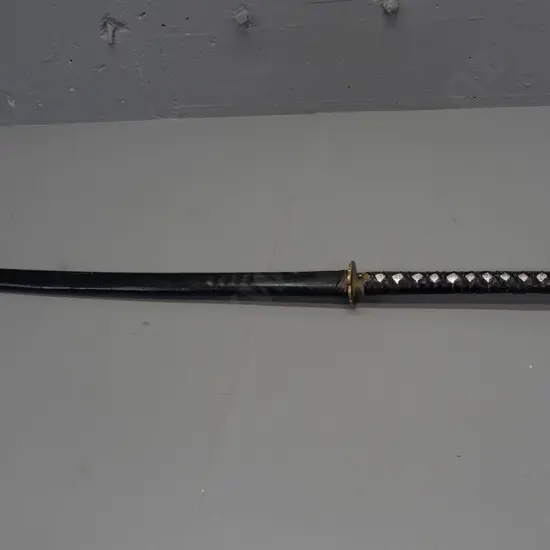 vintage Japanese sword in shark or ray skin covered scabbard, with small knife inset in handle, engraved brass handle