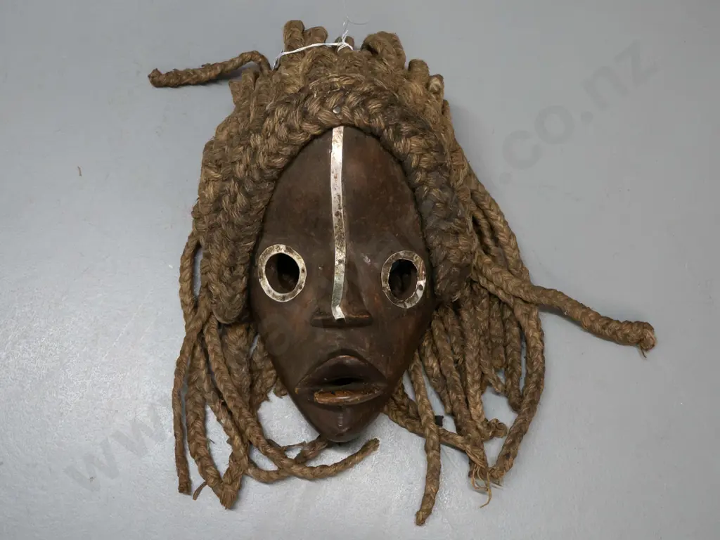 African carved wood Dan mask with metal eye surrounds, plaited fibre hair- Ivory Coast. Wooden part H-250 W-200 Image 1++