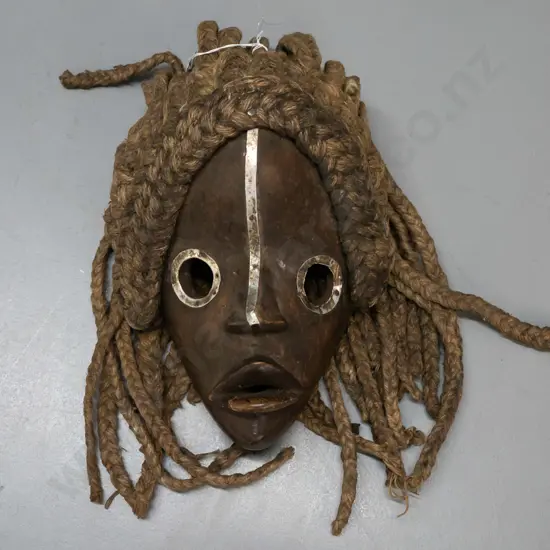 African carved wood Dan mask with metal eye surrounds, plaited fibre hair- Ivory Coast. Wooden part H-250 W-200