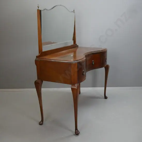 art deco style dressing table with shaped bevelled edge mirror, tapered square supports w/ brass urn finials, serpentine