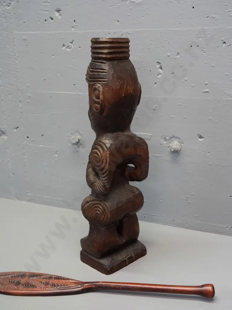 carved timber Maori standing figure with inset paua eyes - crack in base and a small carved timber decorative oar. Image 1++