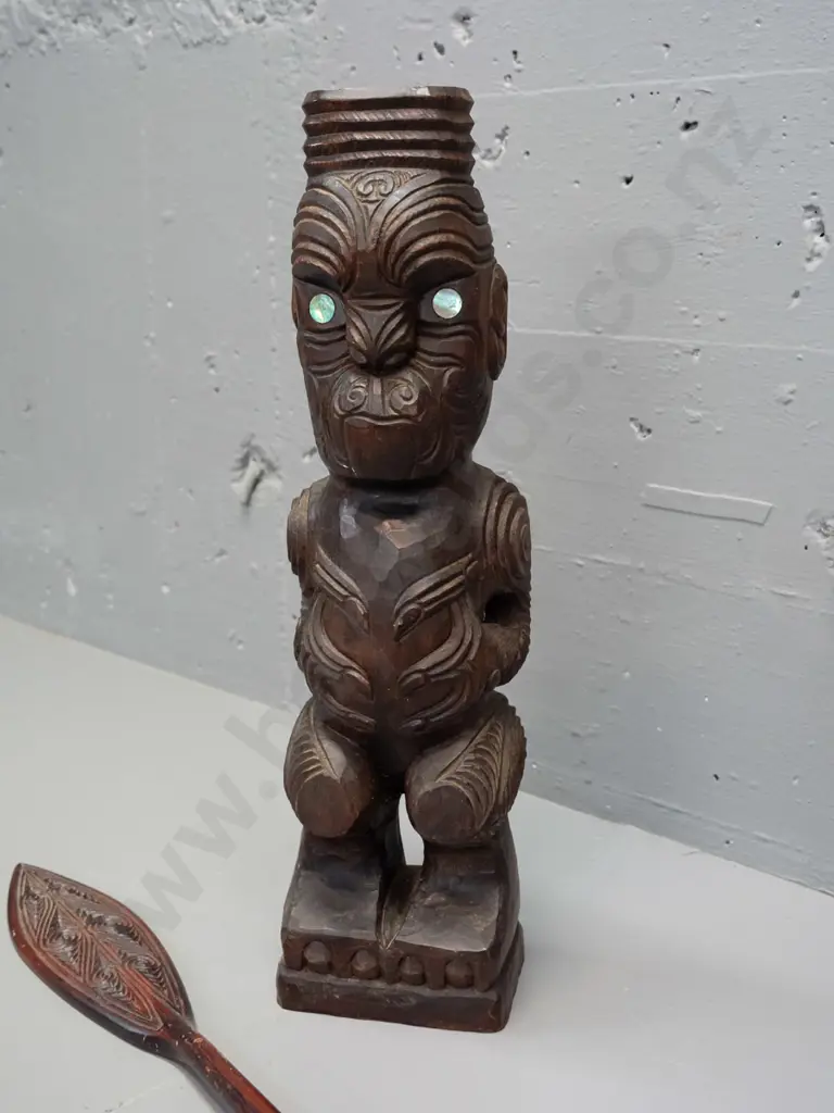 carved timber Maori standing figure with inset paua eyes - crack in base and a small carved timber decorative oar. Image 1++