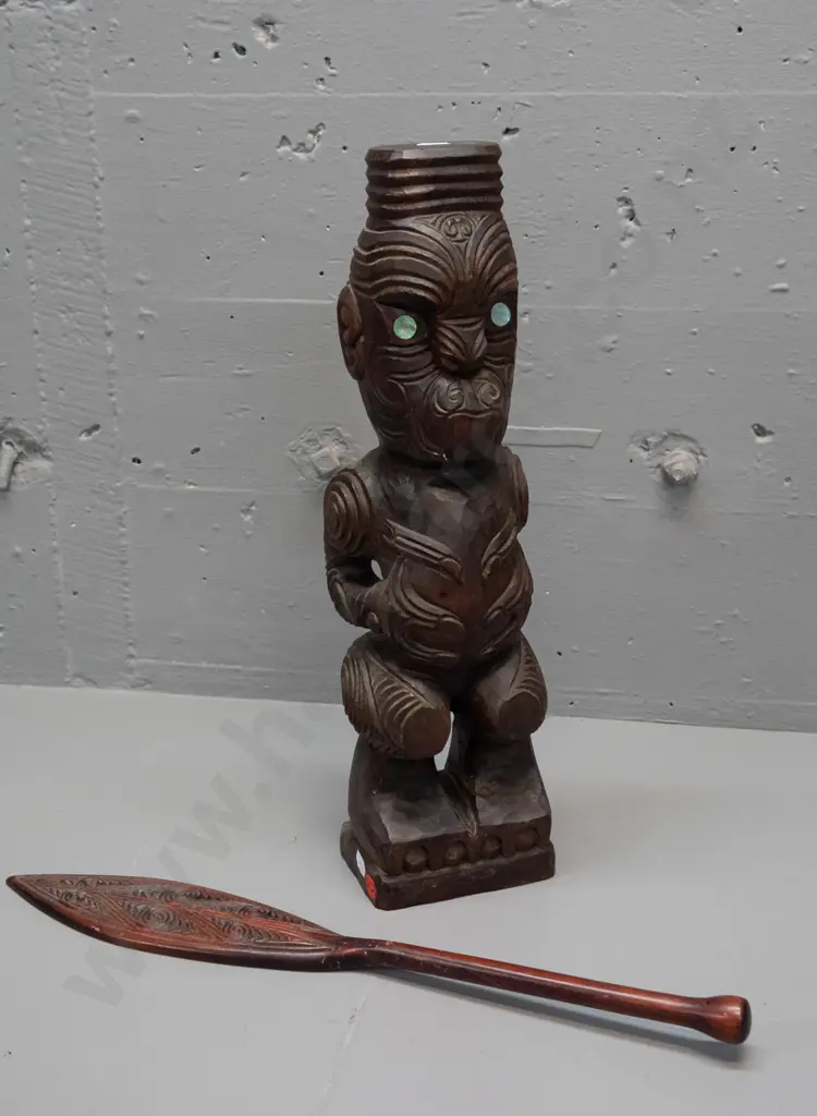 carved timber Maori standing figure with inset paua eyes - crack in base and a small carved timber decorative oar. Image 1++