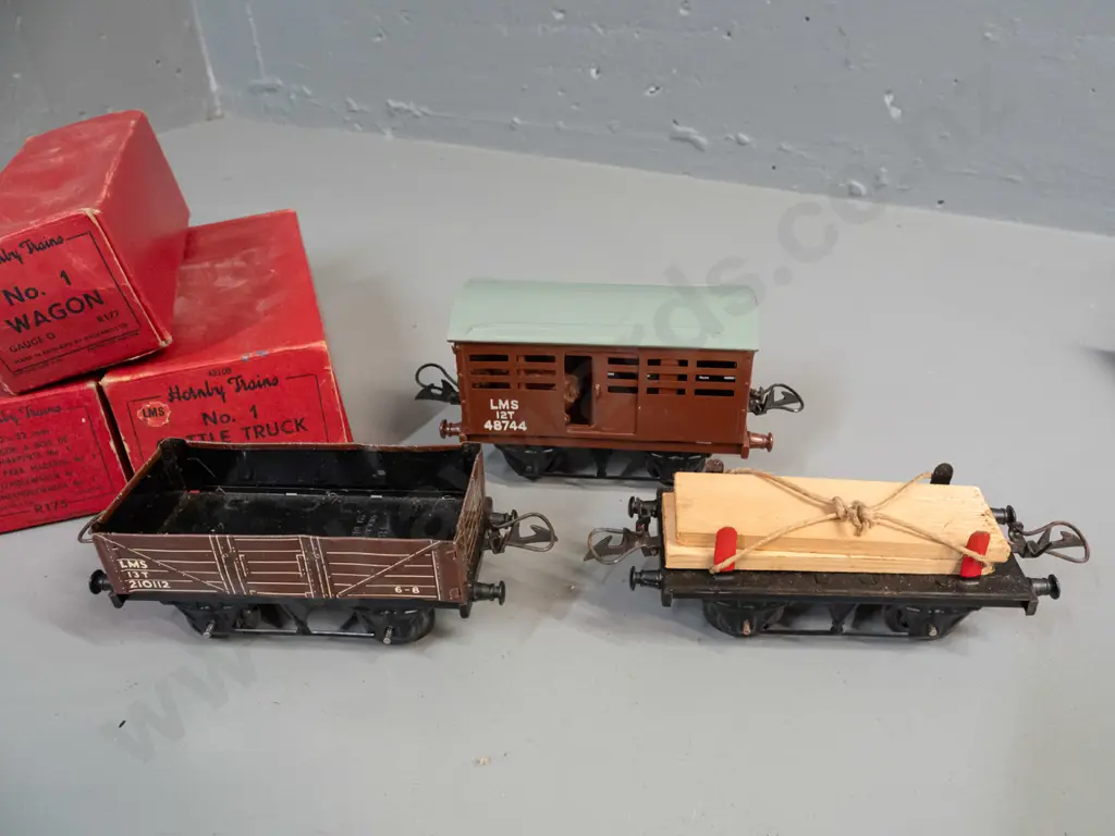 3 boxed Hornby 'O' gauge model railway items in original boxes - timber wagon, cattle truck and LMS wagon - some light Image 1++