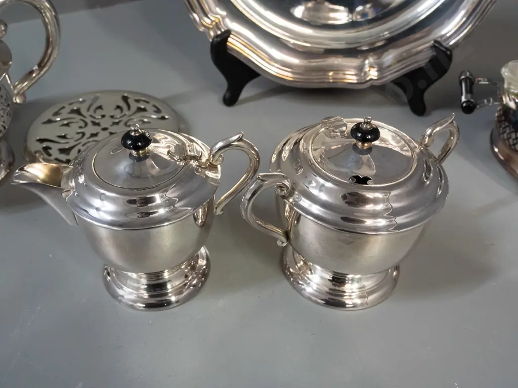 silver plated table ware - teapot on stand, cream & sugar and pyrex dish in plated holder, all with black bakelite or Image 1++