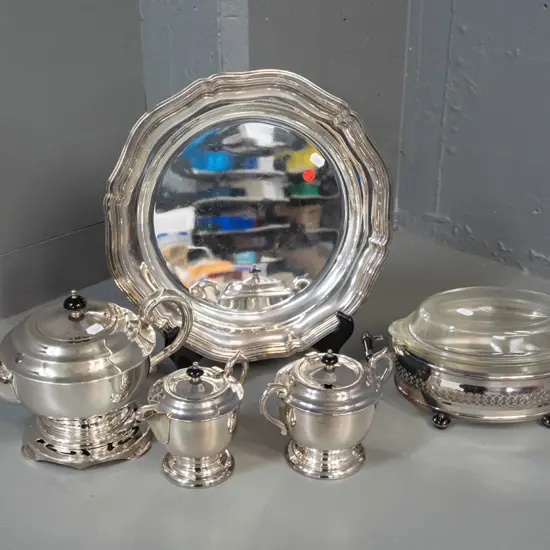 silver plated table ware - teapot on stand, cream & sugar and pyrex dish in plated holder, all with black bakelite or