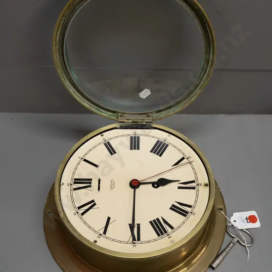 Smiths Astral brass-cased ship's clock with key, bevelled edge glass - some discolouration to brass D-260