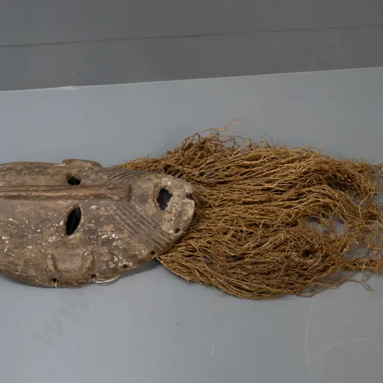 wooden mask with textile or grass fringe, remnants of pigment, Lega tribe, DRC (Congo) - split in nose, some wear to