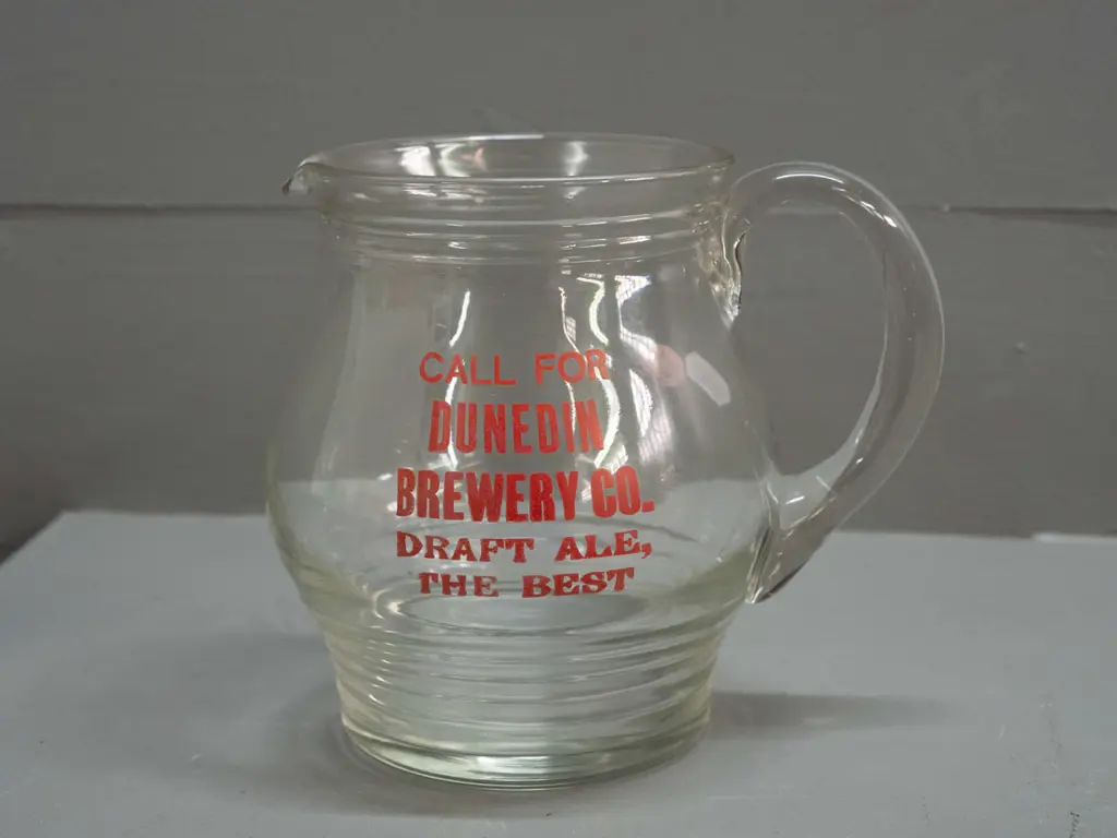 clear glass jug with ribbed base marked "Call for Dunedin Brewery Company Draft Ale - The Best" Minor wear to lettering Image 1++