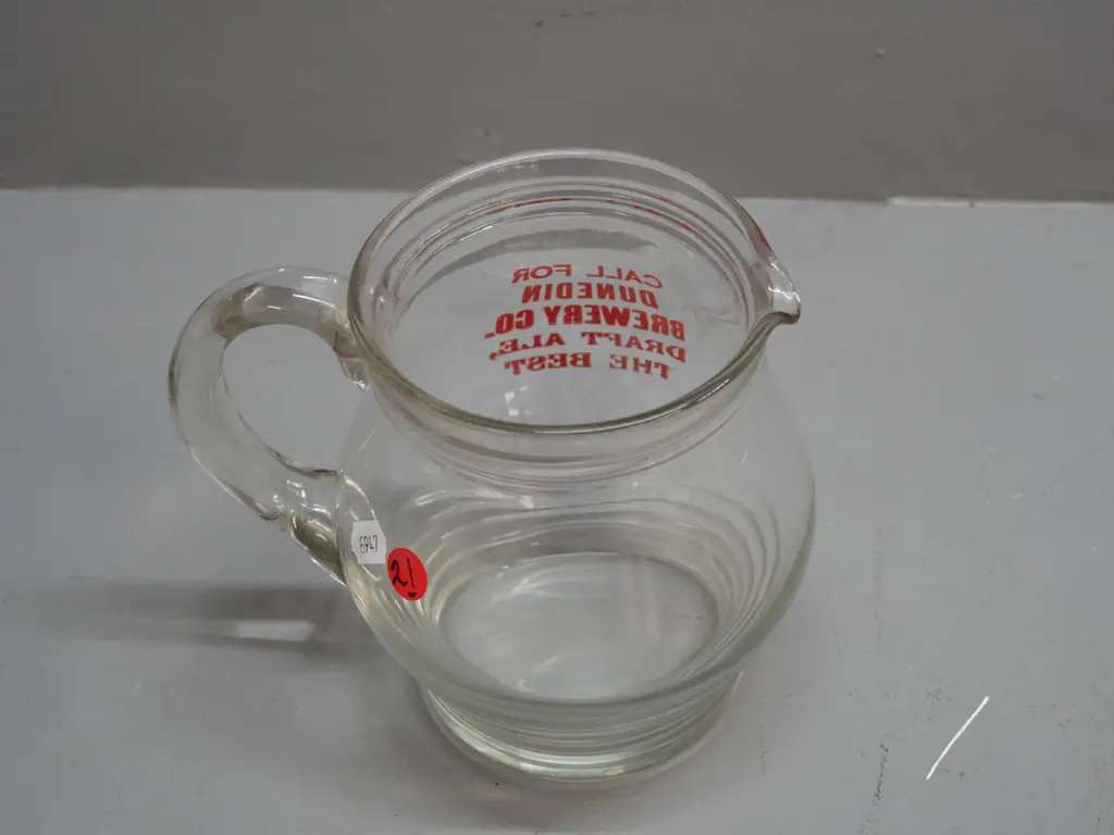 clear glass jug with ribbed base marked "Call for Dunedin Brewery Company Draft Ale - The Best" Minor wear to lettering Image 1++