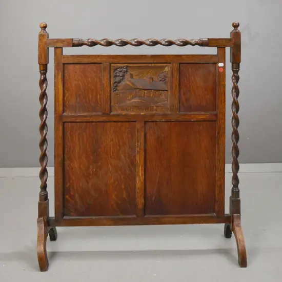 vintage oak fire screen with twist supports and top rail, panelled insert w/ carved panel depicting Burns' cottage,